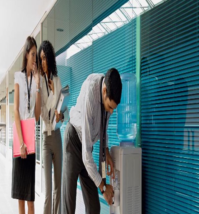 Man at water fountain with women staring at him